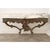 A gorgeous Italian Rococo-style console table from circa 1800 or earlier with original serpentine marble top over a...