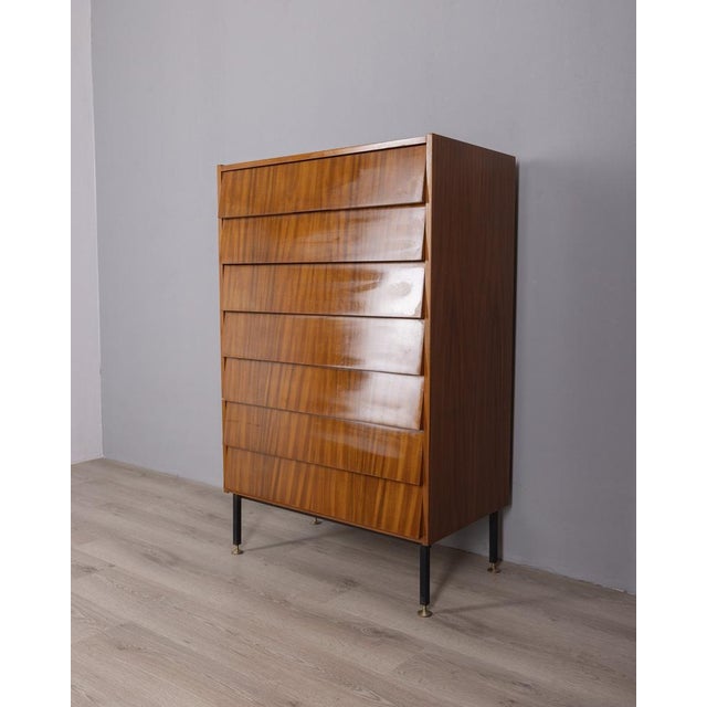 Seven-drawer teak chest of drawers with black metal and gold-plated brass legs, Italian design, 1960s.