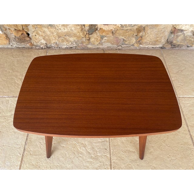 Mid century, vintage side table circa 1960s. Table is made of wood with a striped mahogany veneer finish with nice curved...