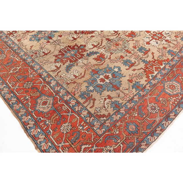 This antique Persian Heriz rug dating back to circa 1920 beautifully captures the essence of its mother-town...