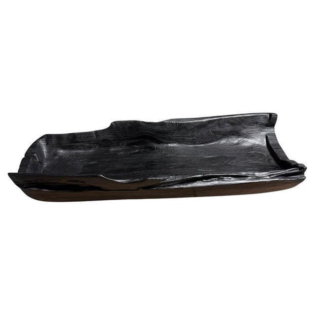 Impressive long charred vessel hand carved from a single piece of reclaimed teak wood. Both usable and sculptural. Charred...