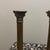 This exquisite pair of candlestick holders showcases timeless sophistication through classical architectural design....