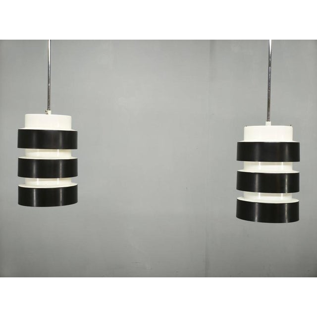 Rare pair of original Mid-Century Modern pendant lights manufactured by Drupol in Czechoslovakia during the 1960s. The...