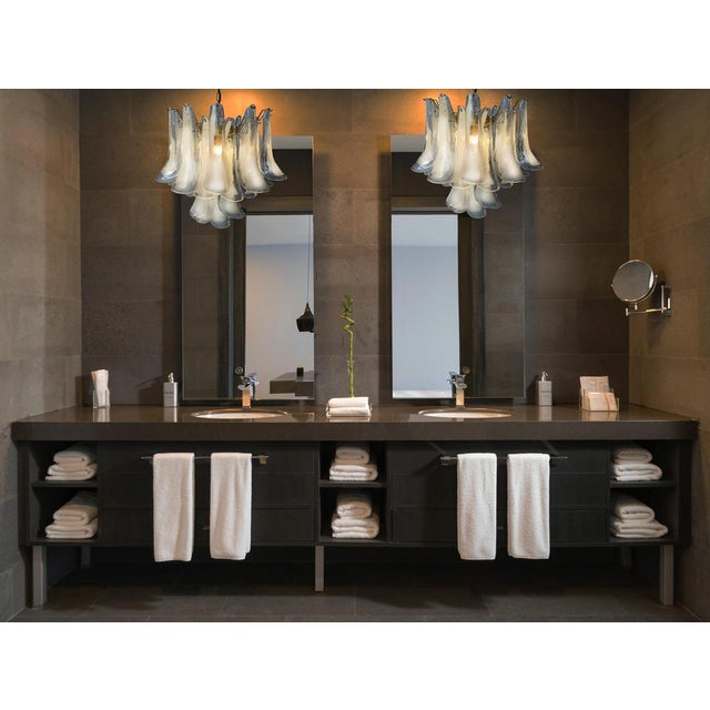 1990’s Murano Italian glass chandelier. Fantastic chandelier with white “lattimo” glasses, gold colored metal frame. It...