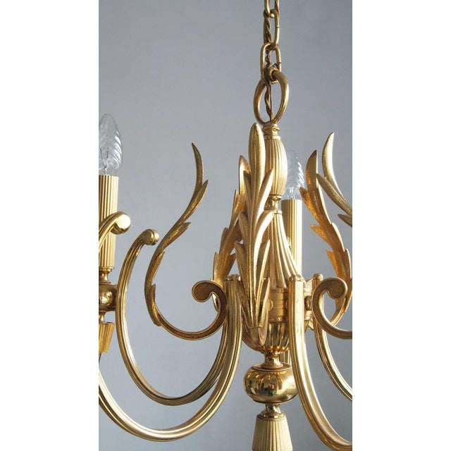 Chandelier with original manufacturer's label. Key design features, such as the laurel slate and finial, are simple and...
