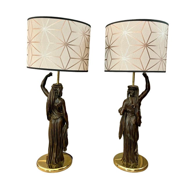 Of French origin made in the 19th century, they represent two caryatids in patinated bronze, this type of lamp known as...