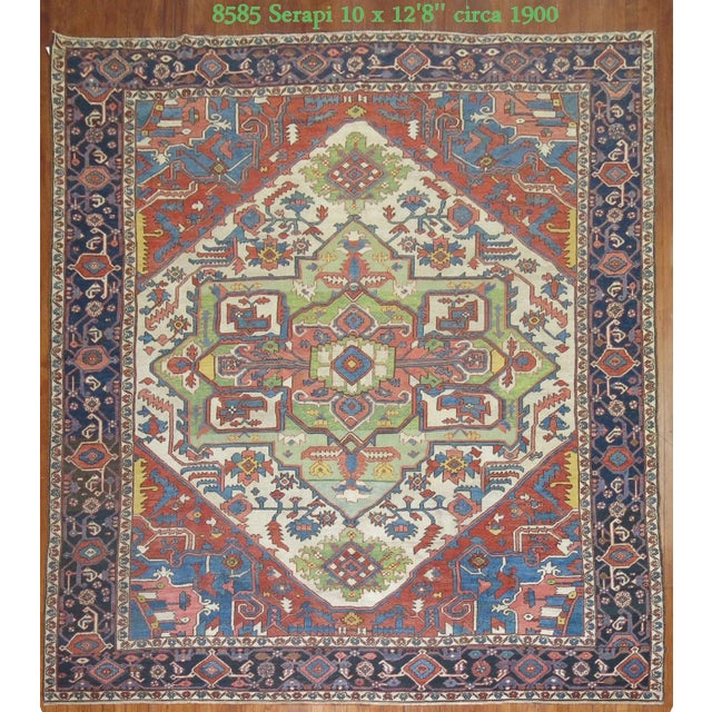 An early 20th century hand-knotted Serapi carpet circa 1900. Antique Serapi carpets were woven on the level of a family or...