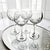Set of four Waterford Crystal Lismore Essence balloon wine glasses produced in Ireland. The glasses feature the Lismore...