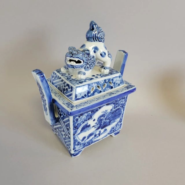 A handsomely crafted Chinese blue and white porcelain censer (xianglu) in an archaic ding form, surmounted by an...