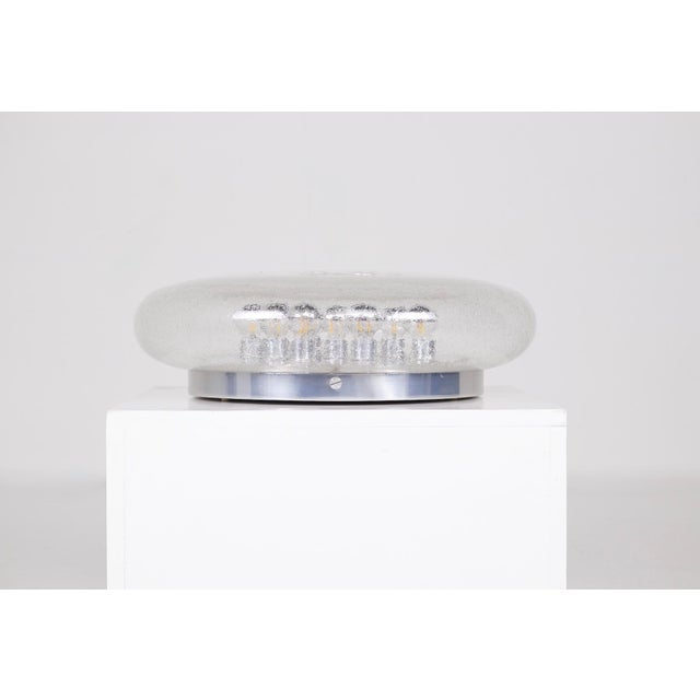 Large round ceiling light made of bubbled blown glass (pulegoso glass), circa 1970. Its thick glass dome with a bubbled...