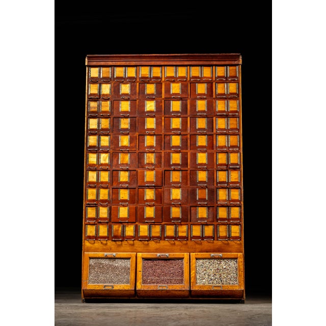 Large, antique wooden cabinet. Beans included! This piece features 88 drawers in two different sizes, each with what...
