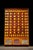 Large, antique wooden cabinet. Beans included! This piece features 88 drawers in two different sizes, each with what...