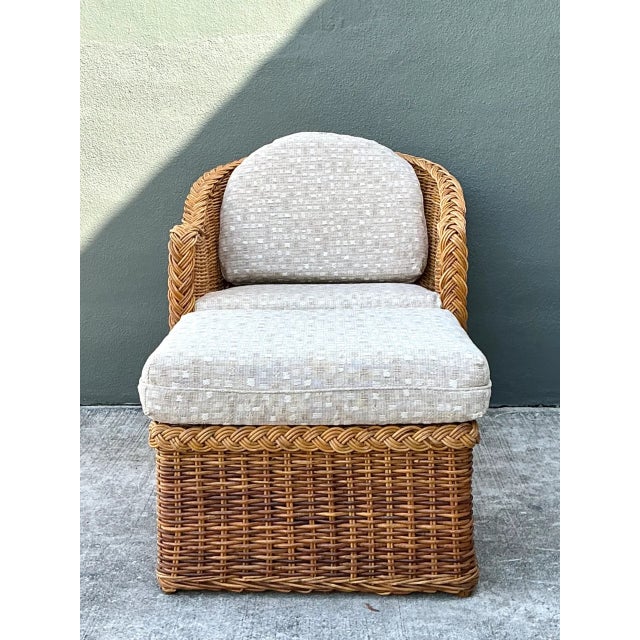 This vintage lounge chair and ottoman set brings the warmth and tactile character of mid-century rattan into a relaxed,...