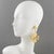 These gorgeous Kenzo Paris clip-on earrings feature a long dangling drop shape with a four-leaf clover design and heart-...