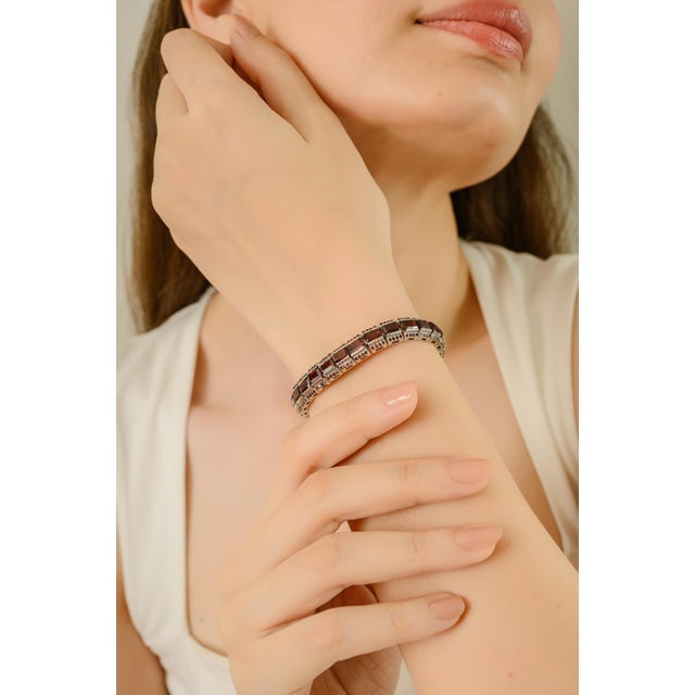 This luxurious bracelet features 925 solid sterling silver adorned with rich garnet gemstones in octagon and round shapes,...