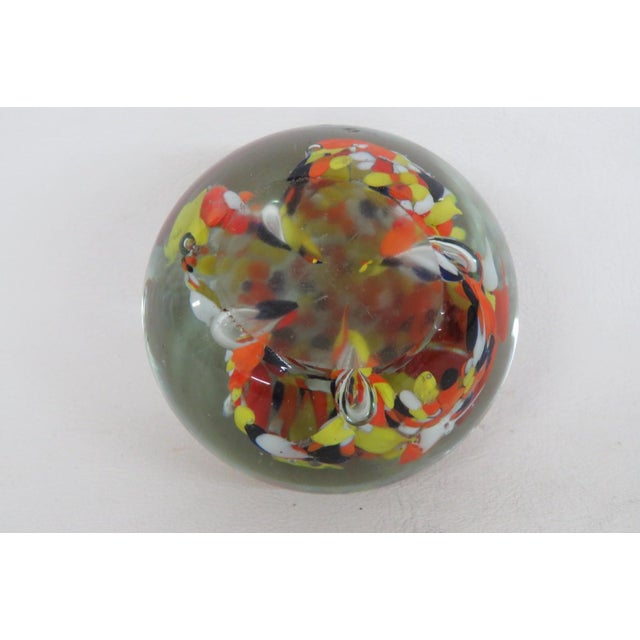This wonderful circular Paper Weight is made of art glass. This gorgeous vintage piece features black with vibrant orange,...