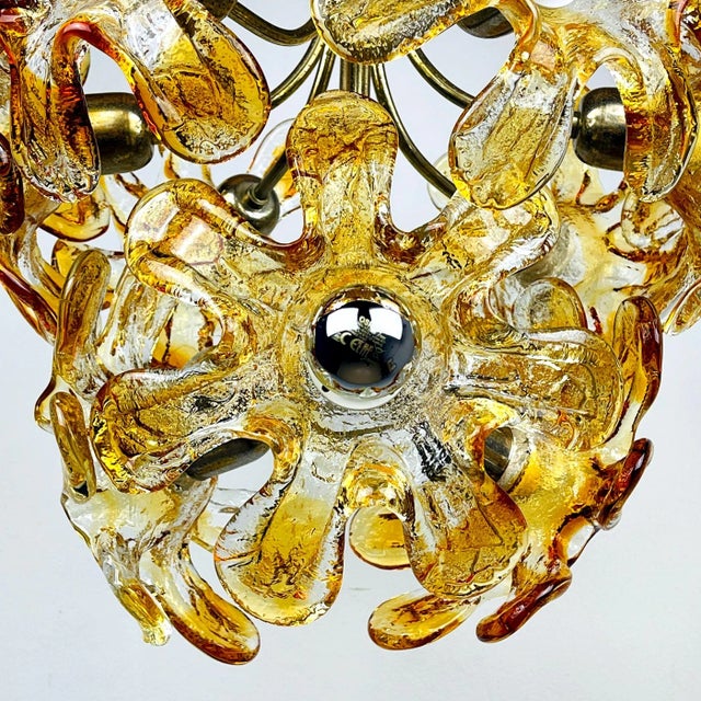 Mid-century amber Murano chandelier with flowers from Mazzega was made in Italy in the 1970s. The glass parts are made of...