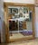 An exceptional vintage Hollywood Regency full-length wall mirror featuring an ornate gold gilt frame with elegant French-...