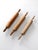 This set of three antique wooden rolling pins adds rustic charm to any kitchen or display. With rich patina, smooth...