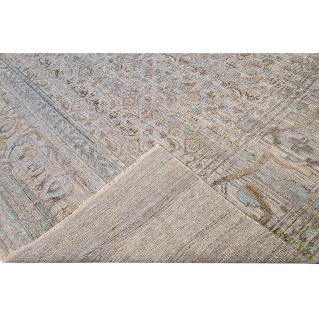 Beautiful modern hand-knotted wool rug with a beige field. This Transitional rug has blue, gray, and brown accents to...
