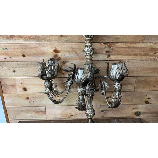 A large-scale vintage wall-mounted candelabra featuring ornate cast metal construction, scrolling arms, floral candle...