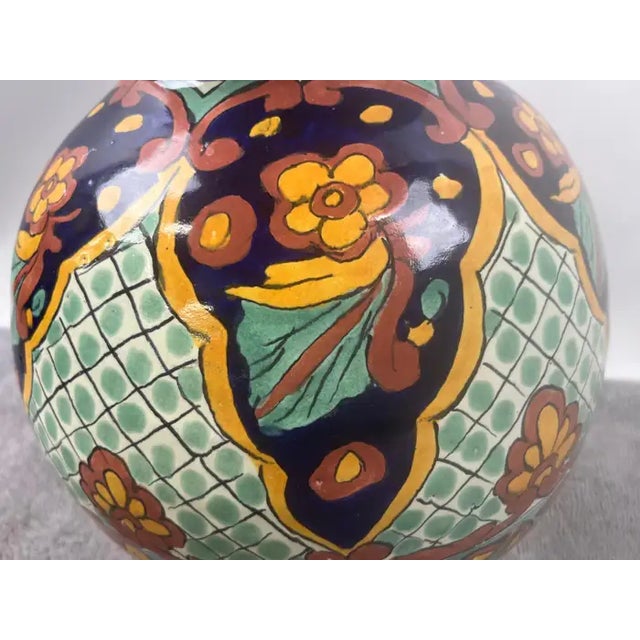 This Mexican Talavera multi-color lidded vase is a striking example of traditional craftsmanship fused with artistic...