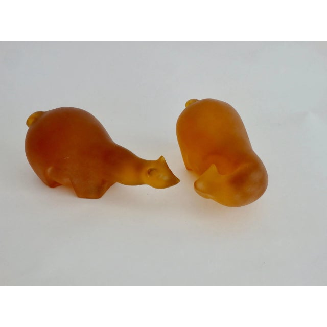 Beautifully styled resin cast sculptures of two polar bears. One looking back and marked Hindsight. The second moving...