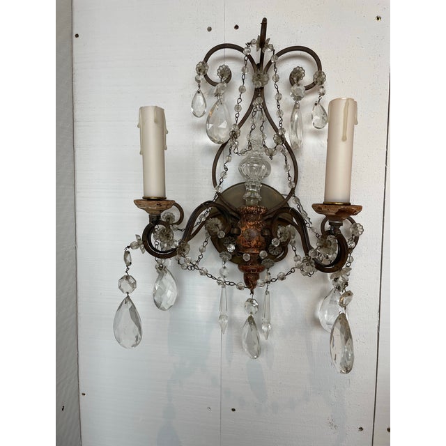A pair of bronze, crystal and wood sconces. Old world charm