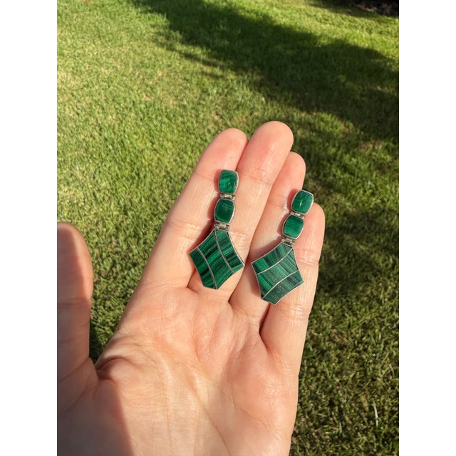 A distinctive pair of circa 1970s vintage articulated drop earrings, composed of richly patterned green malachite set in...