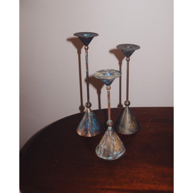 A sculptural set of three bronze candlesticks by Christian de Beaumont, produced in France during the 1980s. Featuring...