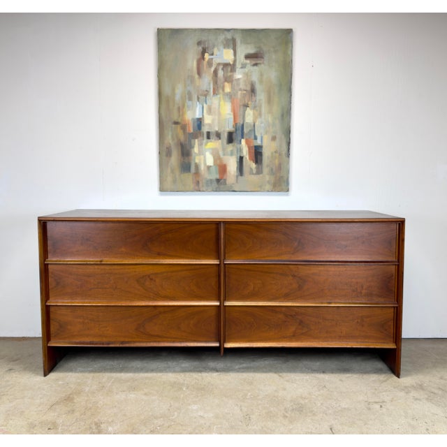 A fabulous and hard to find minimalist walnut dresser by T H Robsjohn Gibbings for Widdicomb circa late 1950’s. Features...