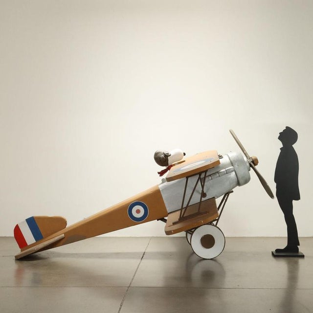 Airplane model with Snoopy Aviator in painted polystyrene. Wooden supports. This piece is attributed to the mentioned...