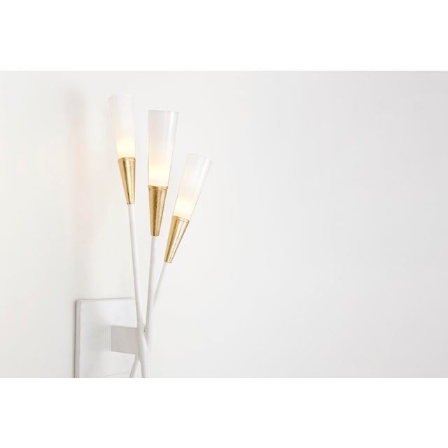 Stellar Triple Tail Sconce in Matte White and Antique Brass with Frosted Acrylic Designer: Chapman & Myers Height: 24"...
