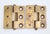 Vintage brass door hinges with button tips, three knuckles, and a template hole pattern. The original mounting screws are...