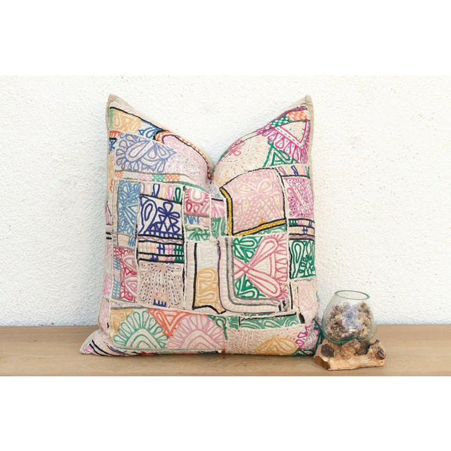 This 22-inch square pillow is a breathtaking example of Rajasthani textile art, handcrafted from rare antique Banjara...