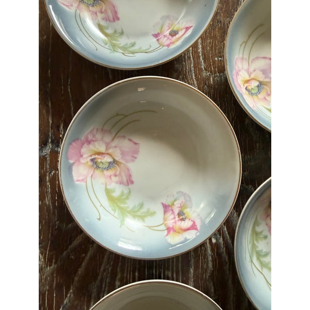 A lovely set of five vintage German porcelain bowls decorated with soft pink poppy flowers, delicate green foliage, and a...
