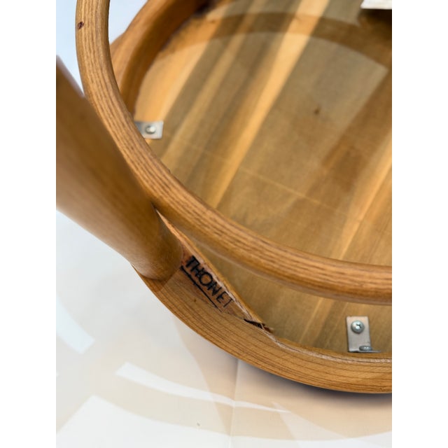 A graceful vintage café chair by Thonet, pairing the fluid lines of bentwood construction with a softly upholstered seat....