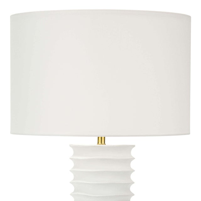 A tactile white finish on the Nabu metal column table lamp accentuates its accordion-like base. Its simple, yet artisan...