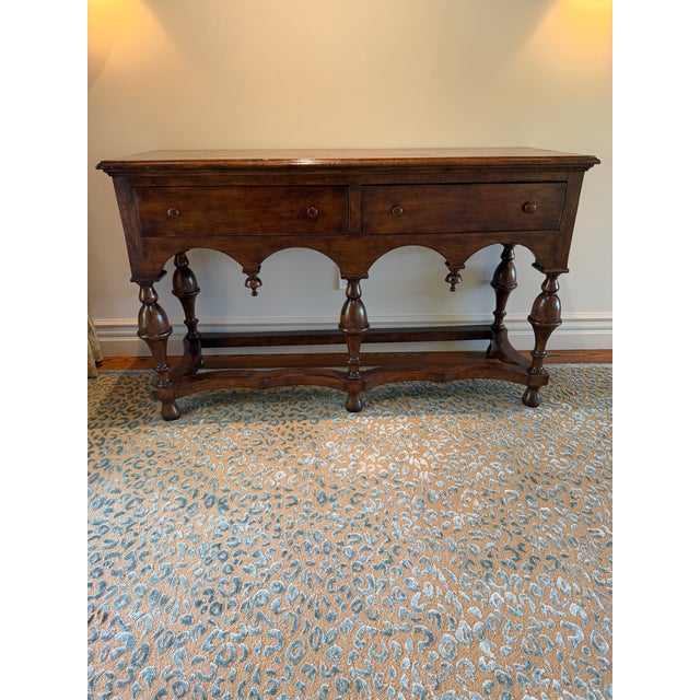 Beautiful traditional walnut console or serving table featuring a rich, warm wood finish and distinctive Old World...