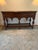 Beautiful traditional walnut console or serving table featuring a rich, warm wood finish and distinctive Old World...