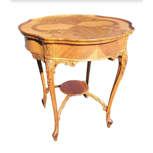 Louis XV Style Marquetry and Carved Walnut and Mahogany Center Table with stretcher for greater stability. Intricate...