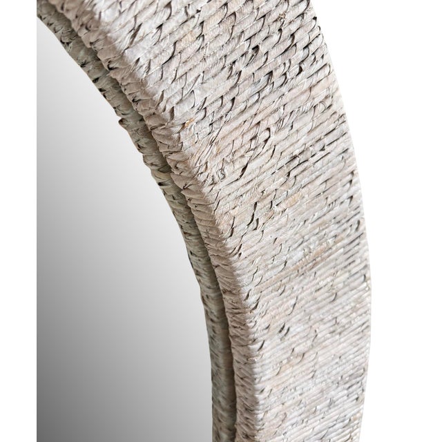 Contemporary coastal style white wash wicker framed round wall mirror. Beautiful above a console or vanity, among other...