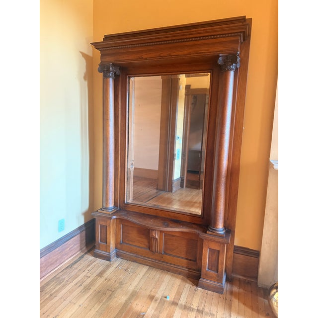 Stately freestanding antique Victorian oak pier mirror with Ionic-style column capitals, an egg-and-dart moulded cornice,...