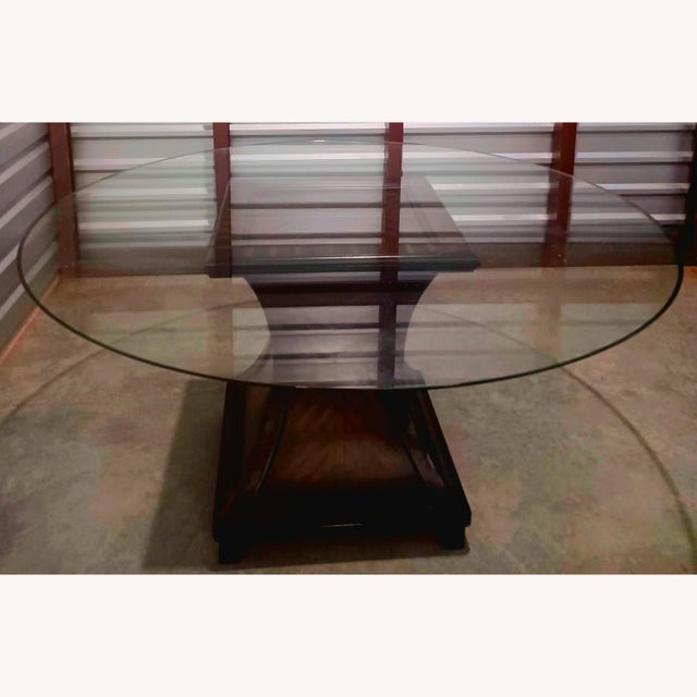 This beautifully made, dining table has a wooden pedestal base comes which comes with a thicken glass. The glass is...