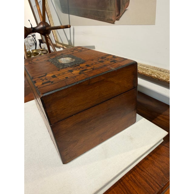 This is an antique Victorian burr walnut inlaid box. It features intricate geometric parquetry, a type of wood mosaic...