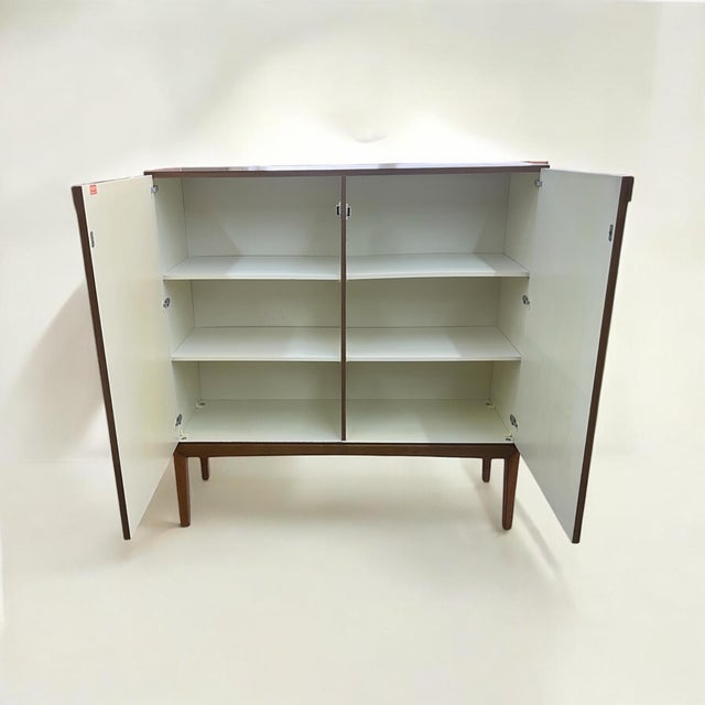 This mid-century german highboard from palette möbelwerke from wernau is a typical product from this manufacturer from the...