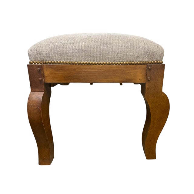 A distinctive French Provincial–Louis XV-style upholstered bench featuring a solid wood frame, shaped apron, sculptural...