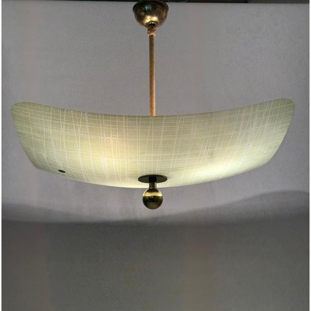 This is a lovely chandelier with a classic look. It's from the 1950s, so it's a bit dated, but that only adds to its...