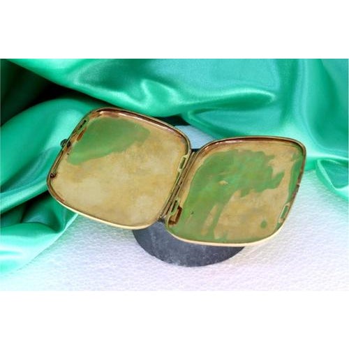 Women's gold cigarette case with strips and bands at the top and garnet cabochon on the clasp. Metal: Gold. Origin:...