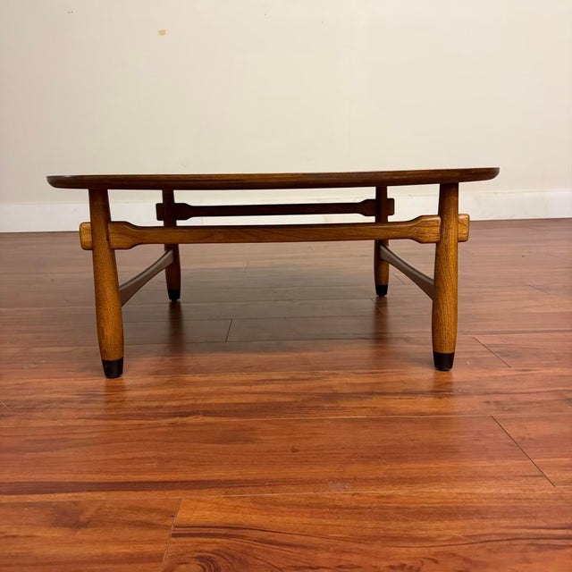 Vintage mid-century coffee table made in the U.S. by Lane in 1959. This piece features a walnut veneer top with inlaid...